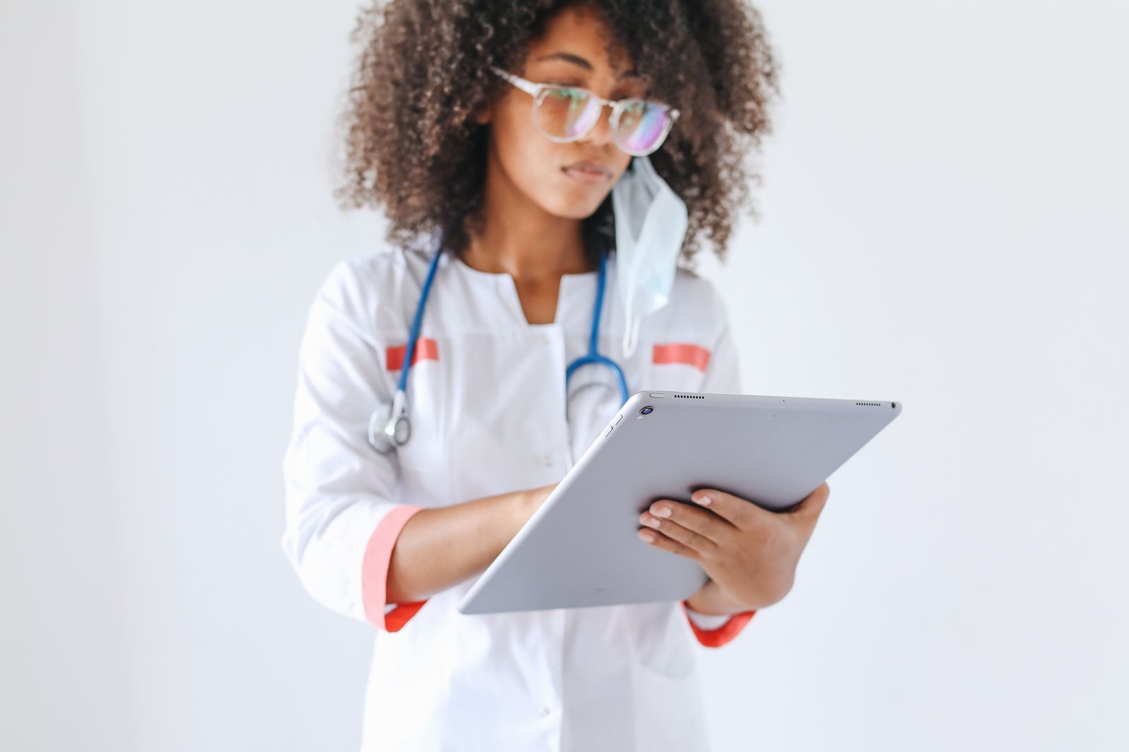 A healthcare professional reviewing information on a tablet