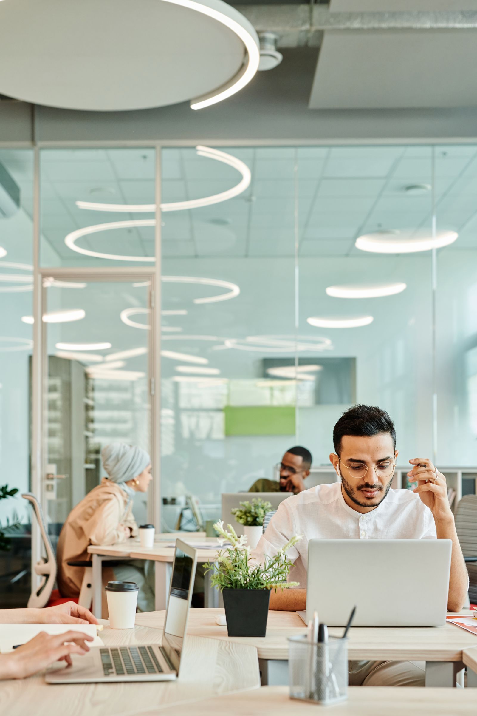 A small team working together around laptops in a modern office