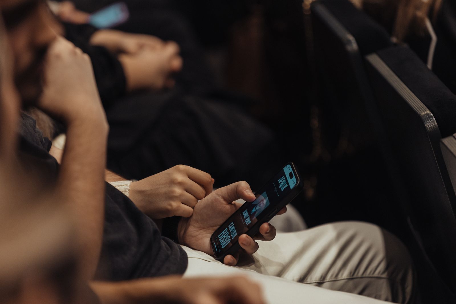 An attendee using a smartphone during a technology conference