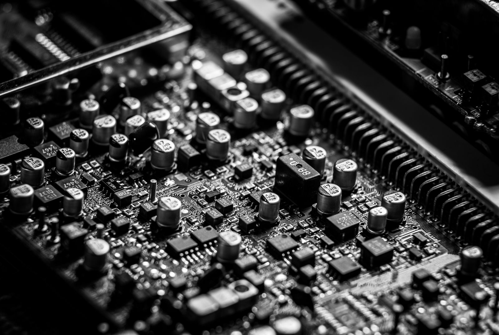 Black-and-white close-up of electronic components on a circuit board